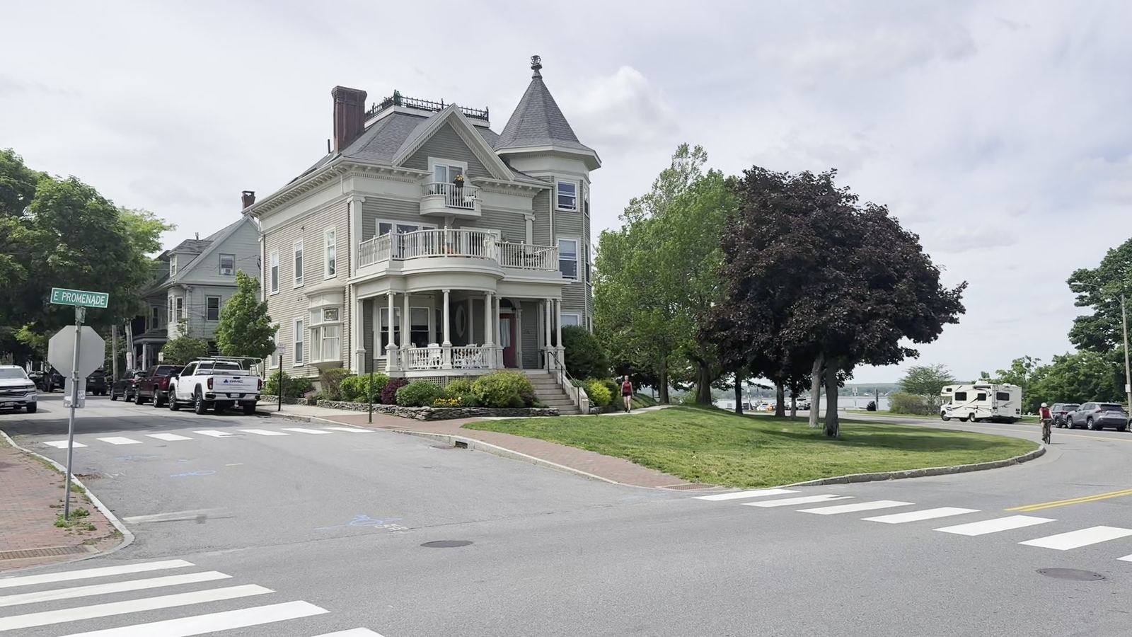 A large Victorian house on a corner of Portland's Eastern Promenade, with Casco Bay behind it